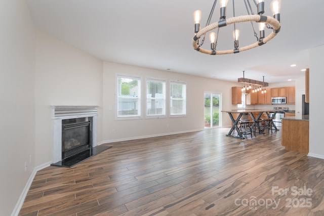 1144 Spicewood Pines Rd, Fort Mill, SC 29708 - living room with a chandelier, dark wood-style floors, baseboards, a glass covered fireplace, and recessed lighting