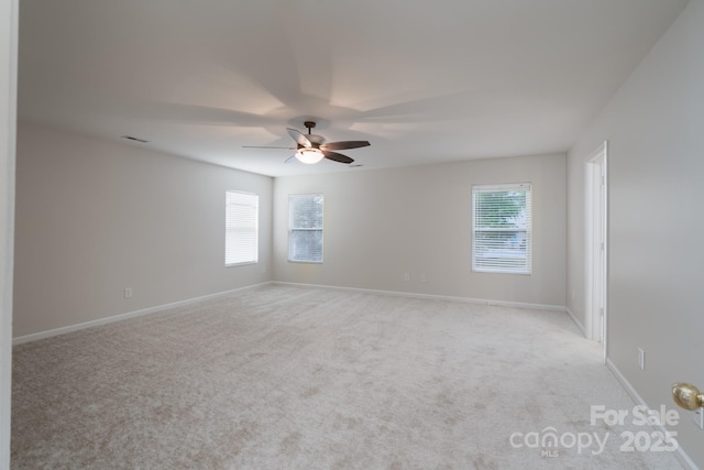 1144 Spicewood Pines Rd, Fort Mill, SC 29708 - empty room with plenty of natural light, a ceiling fan, light carpet, and baseboards