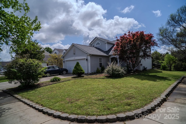 view of front of property with roof with shingles, concrete driveway, a front yard, and a garage