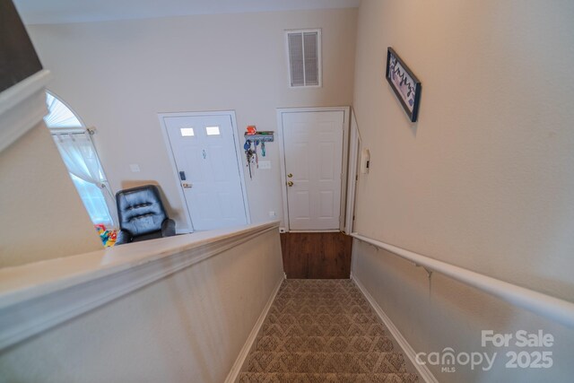 stairs with baseboards and visible vents