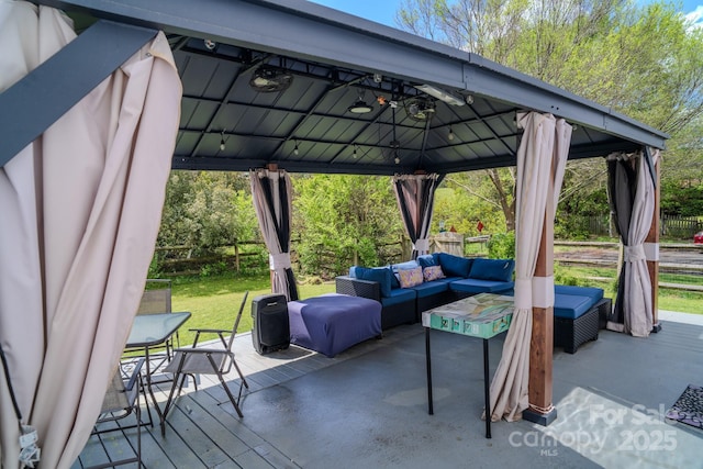 exterior space featuring fence, a gazebo, outdoor lounge area, and a wooden deck