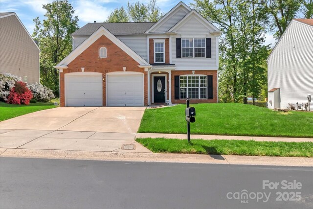 traditional-style house with an attached garage, driveway, brick siding, and a front yard