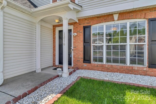 property entrance with brick siding