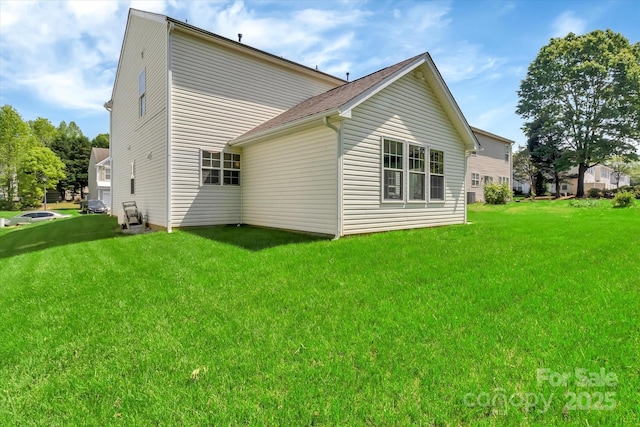 back of property featuring a lawn