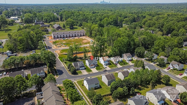 aerial view featuring a residential view and a wooded view