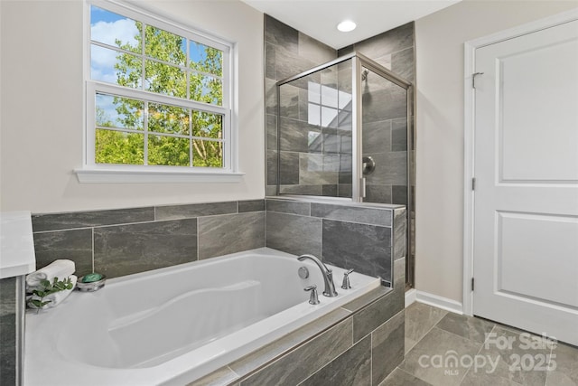 full bath with baseboards, recessed lighting, a stall shower, and a garden tub