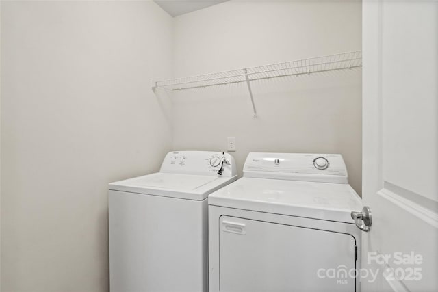 clothes washing area featuring washer and clothes dryer and laundry area