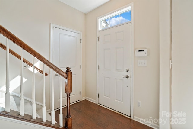 entryway featuring stairway, baseboards, and dark wood-style flooring