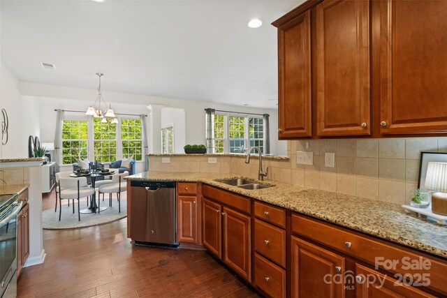 kitchen with dark wood-style floors, a sink, decorative backsplash, stainless steel appliances, and visible vents