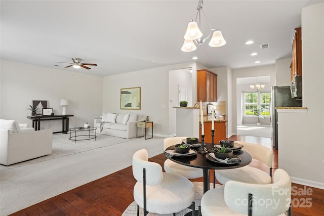 dining room with baseboards, recessed lighting, light wood-style floors, visible vents, and ceiling fan with notable chandelier