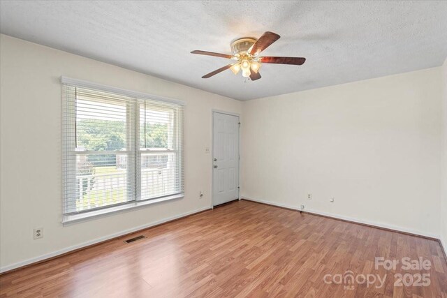 1504 Andicot Ln, Shelby, NC 28152 - unfurnished room with wood finished floors, a ceiling fan, and a textured ceiling