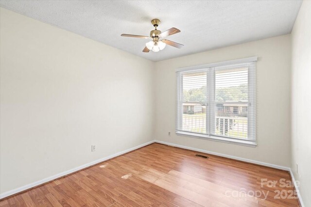 1504 Andicot Ln, Shelby, NC 28152 - unfurnished room with healthy amount of natural light, light wood finished floors, and ceiling fan