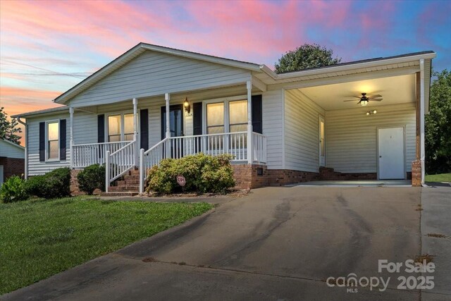 1504 Andicot Ln, Shelby, NC 28152 - ranch-style home featuring concrete driveway, a carport, a porch, and a front yard