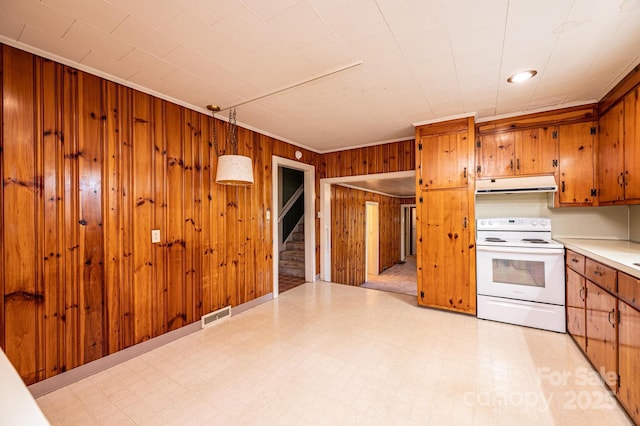 kitchen featuring visible vents, ventilation hood, brown cabinetry, white electric range oven, and light floors