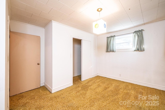 empty room with light colored carpet and baseboards