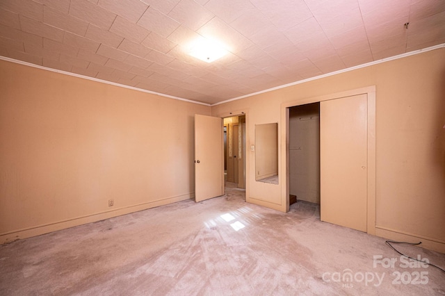 unfurnished bedroom with light colored carpet and crown molding