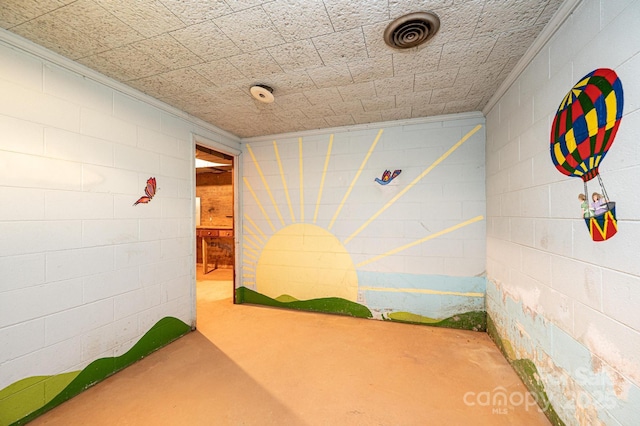 game room with visible vents and concrete block wall
