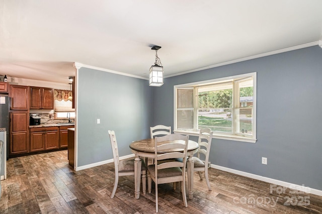 dining space with baseboards, crown molding, and dark wood-type flooring