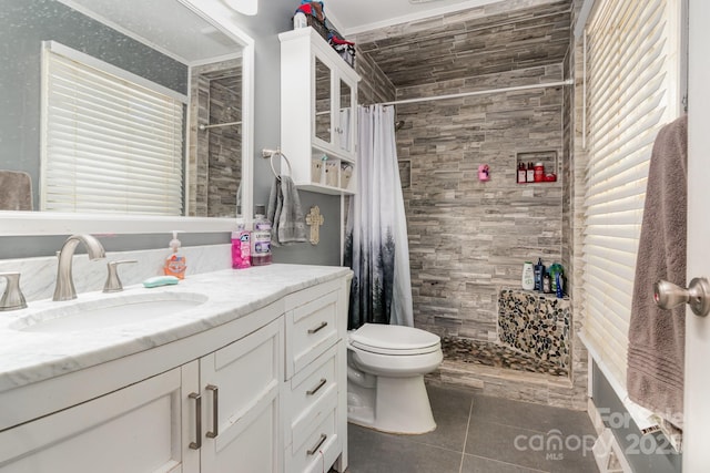 bathroom featuring a stall shower, vanity, tile patterned flooring, and toilet