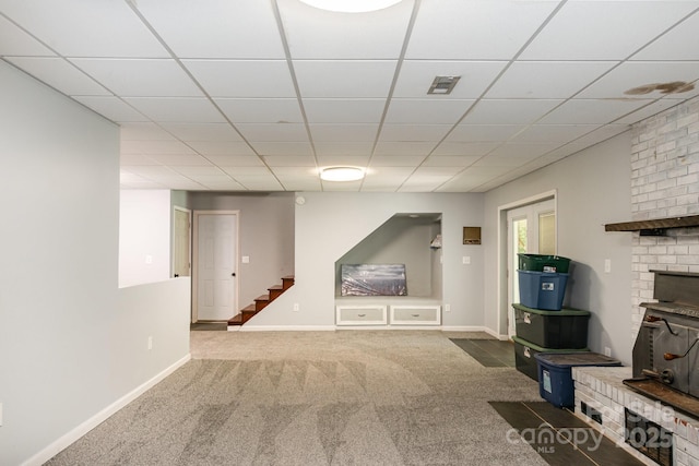 unfurnished living room featuring carpet, visible vents, baseboards, and stairway