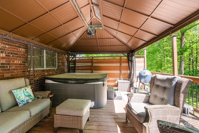wooden terrace featuring a gazebo and a hot tub