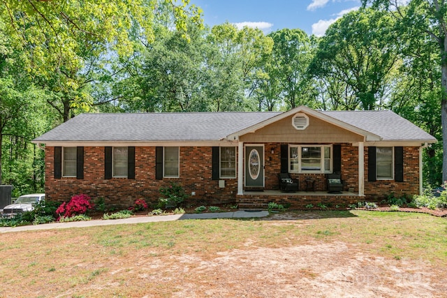 ranch-style house with brick siding, a porch, and a shingled roof