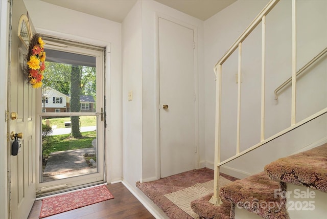 entrance foyer featuring wood finished floors and baseboards