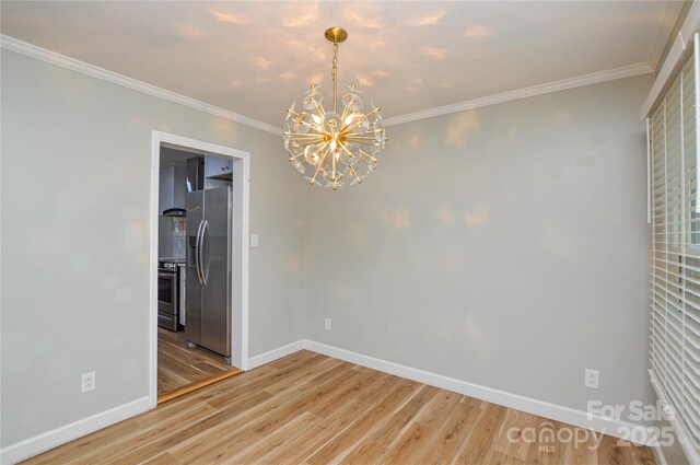 10805 Winterbourne Ct, Charlotte, NC 28277 - spare room with a chandelier, light wood finished floors, baseboards, and ornamental molding