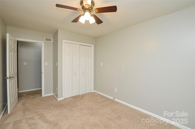 10805 Winterbourne Ct, Charlotte, NC 28277 - unfurnished bedroom with a closet, light colored carpet, a ceiling fan, visible vents, and baseboards