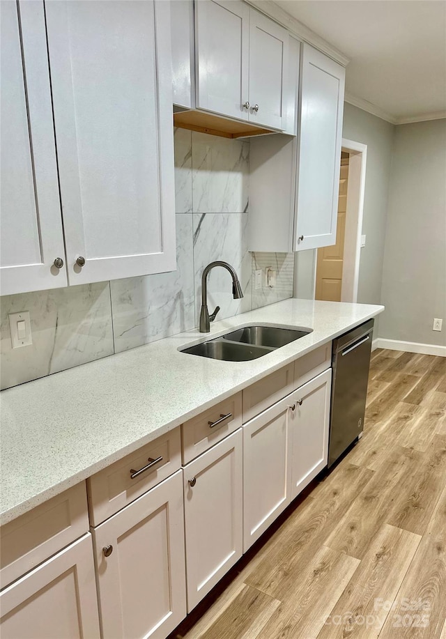 10805 Winterbourne Ct, Charlotte, NC 28277 - kitchen featuring crown molding, stainless steel dishwasher, light wood-style flooring, white cabinetry, and a sink