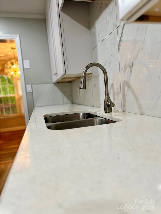 10805 Winterbourne Ct, Charlotte, NC 28277 - interior details with a sink, decorative backsplash, white cabinetry, and light stone countertops