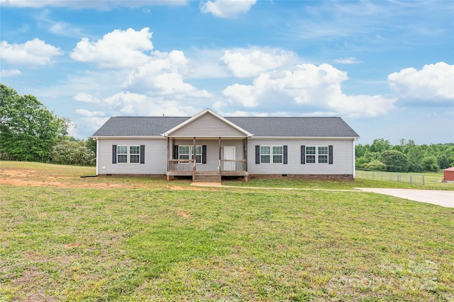 ranch-style house with fence, a shingled roof, a front lawn, and crawl space