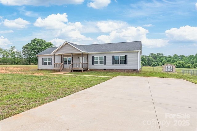 ranch-style house with an outbuilding, crawl space, a front yard, a shed, and a porch