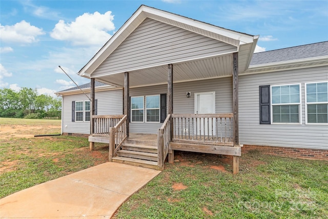view of front of home with a porch, a front lawn, and crawl space
