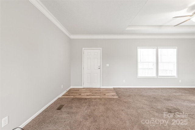 empty room featuring visible vents, crown molding, ceiling fan, carpet flooring, and baseboards