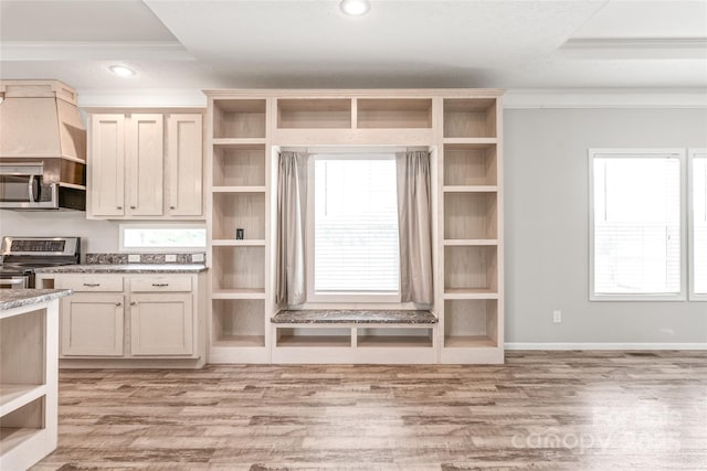 kitchen with open shelves, crown molding, light wood-style flooring, baseboards, and appliances with stainless steel finishes
