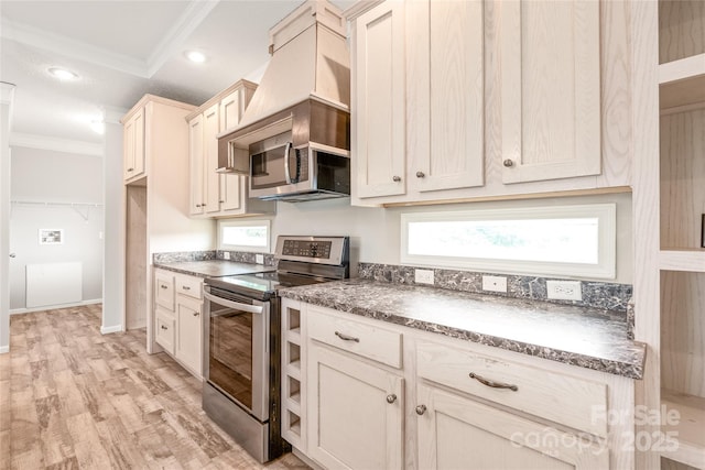 kitchen with stainless steel range with electric stovetop, light wood-style flooring, wall chimney exhaust hood, ornamental molding, and recessed lighting