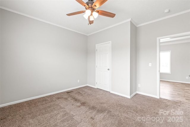 unfurnished bedroom featuring baseboards, ornamental molding, ceiling fan, and carpet