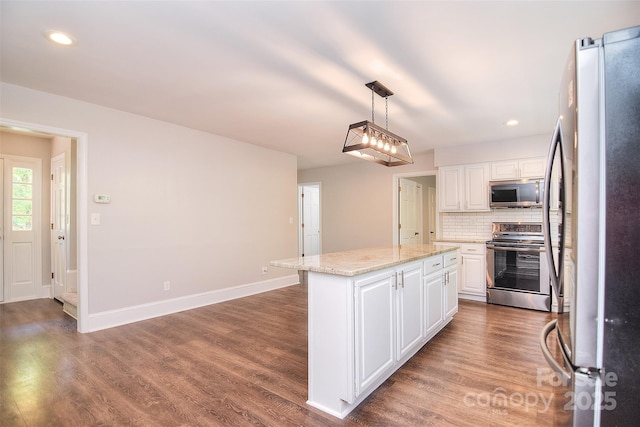 6008 Corkstone Dr, Mint Hill, NC 28227 - kitchen featuring appliances with stainless steel finishes, white cabinetry, a center island, wood finished floors, and recessed lighting