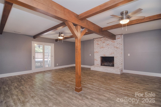 6008 Corkstone Dr, Mint Hill, NC 28227 - unfurnished living room featuring a ceiling fan, baseboards, beam ceiling, wood finished floors, and a fireplace