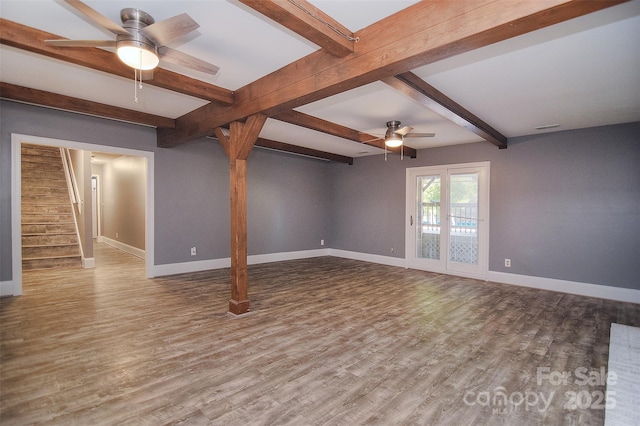 6008 Corkstone Dr, Mint Hill, NC 28227 - spare room featuring a ceiling fan, baseboards, beam ceiling, wood finished floors, and stairway