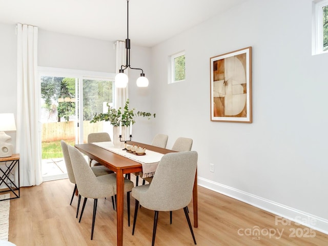 dining room with light wood-type flooring and baseboards