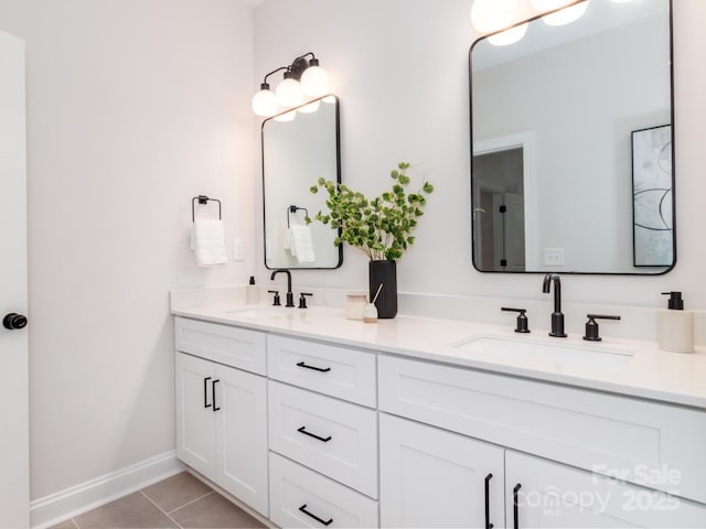 full bathroom with tile patterned floors, baseboards, and double vanity