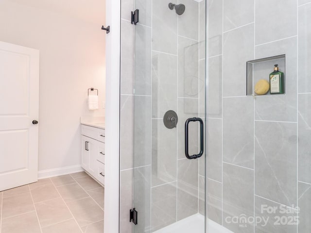 full bath with a stall shower and vanity