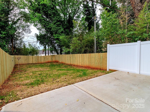 fenced backyard featuring a patio area