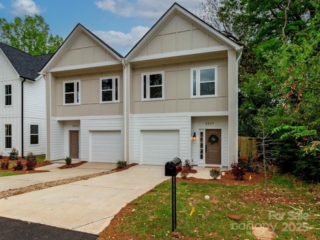 townhome / multi-family property with board and batten siding, an attached garage, and driveway