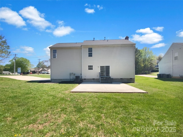 back of property with a patio, central AC unit, crawl space, and a lawn