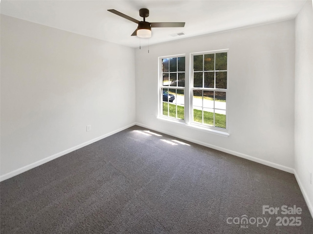 unfurnished room with carpet, visible vents, baseboards, and ceiling fan