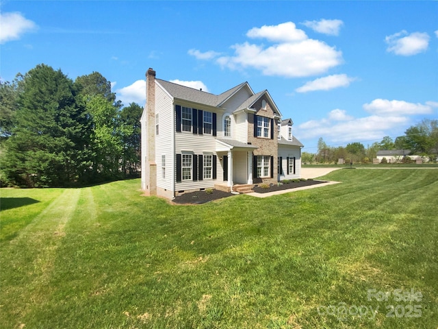view of side of property with crawl space, a chimney, and a lawn