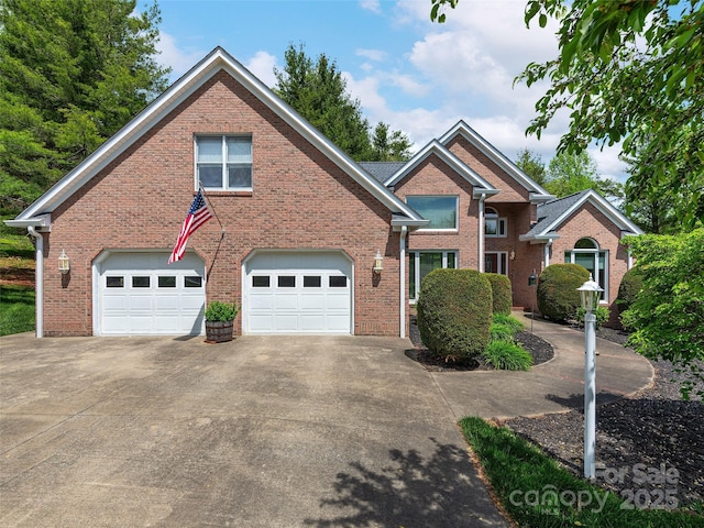 view of front of house with a garage, brick siding, and concrete driveway